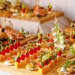 buffet table with snacks from burgers cheeses etc